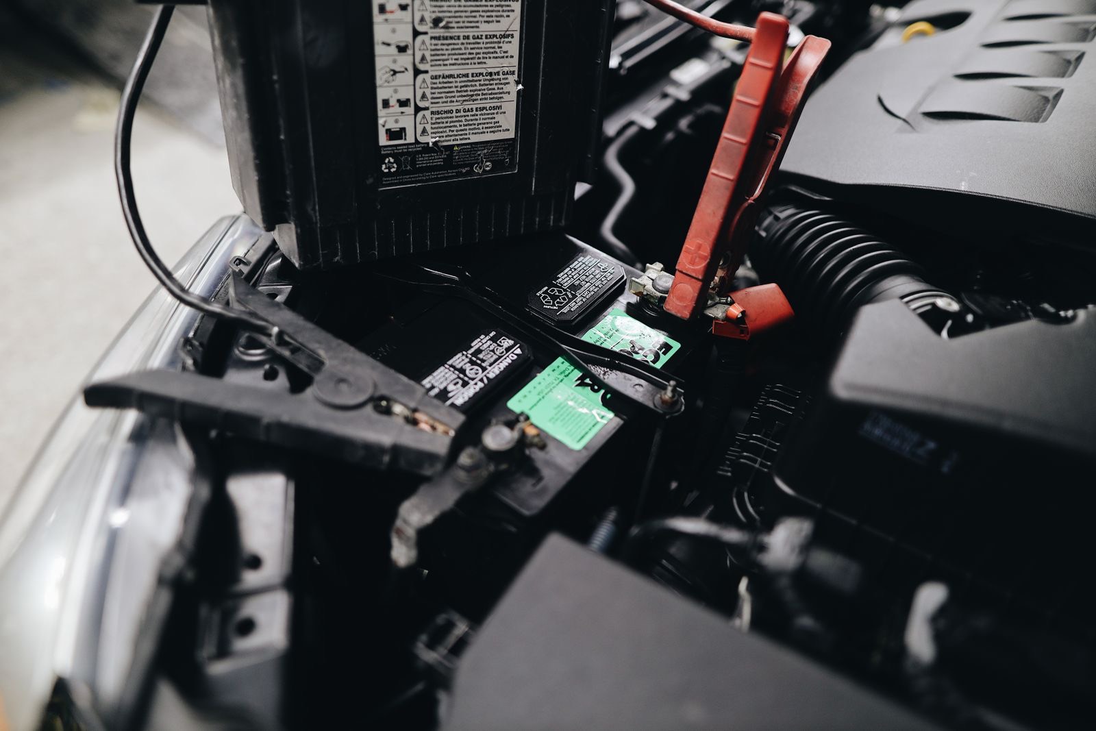 Jump leads attached to a car battery