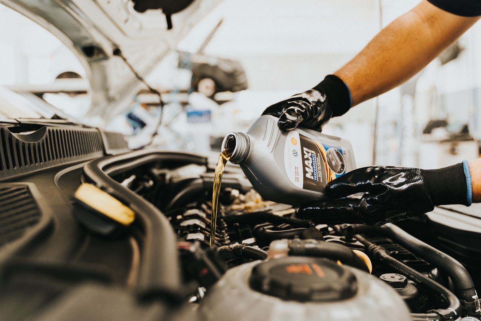 A mechanic carrying out a car service